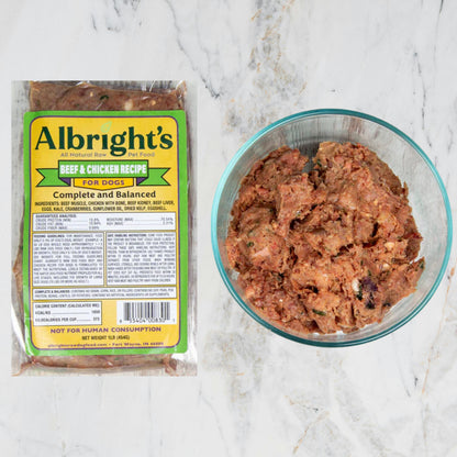 Albright's dog food package and bowl of dog food on a marble surface