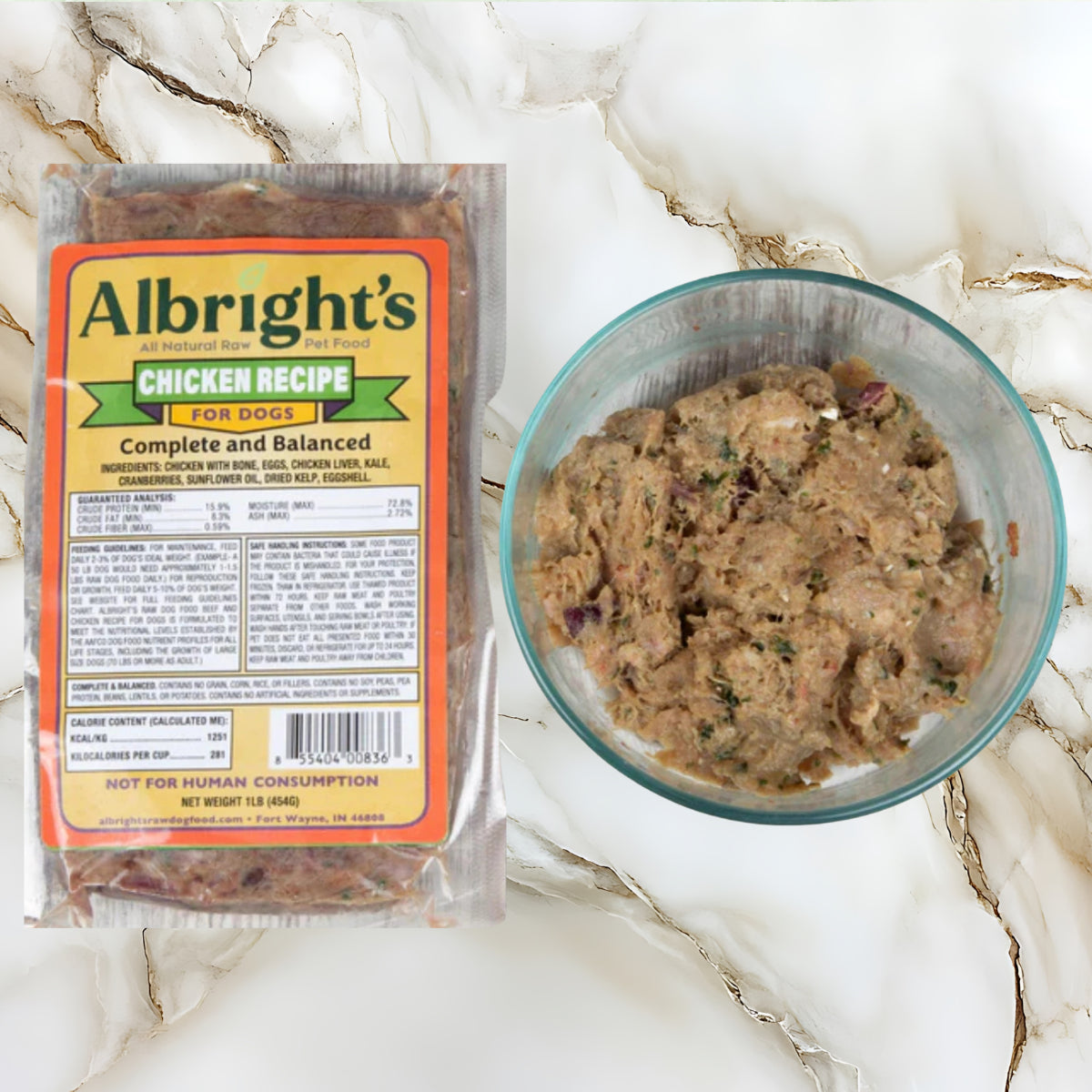 Albright’s Chicken Complete and Balanced raw dog food package displayed beside prepared raw meal in a bowl