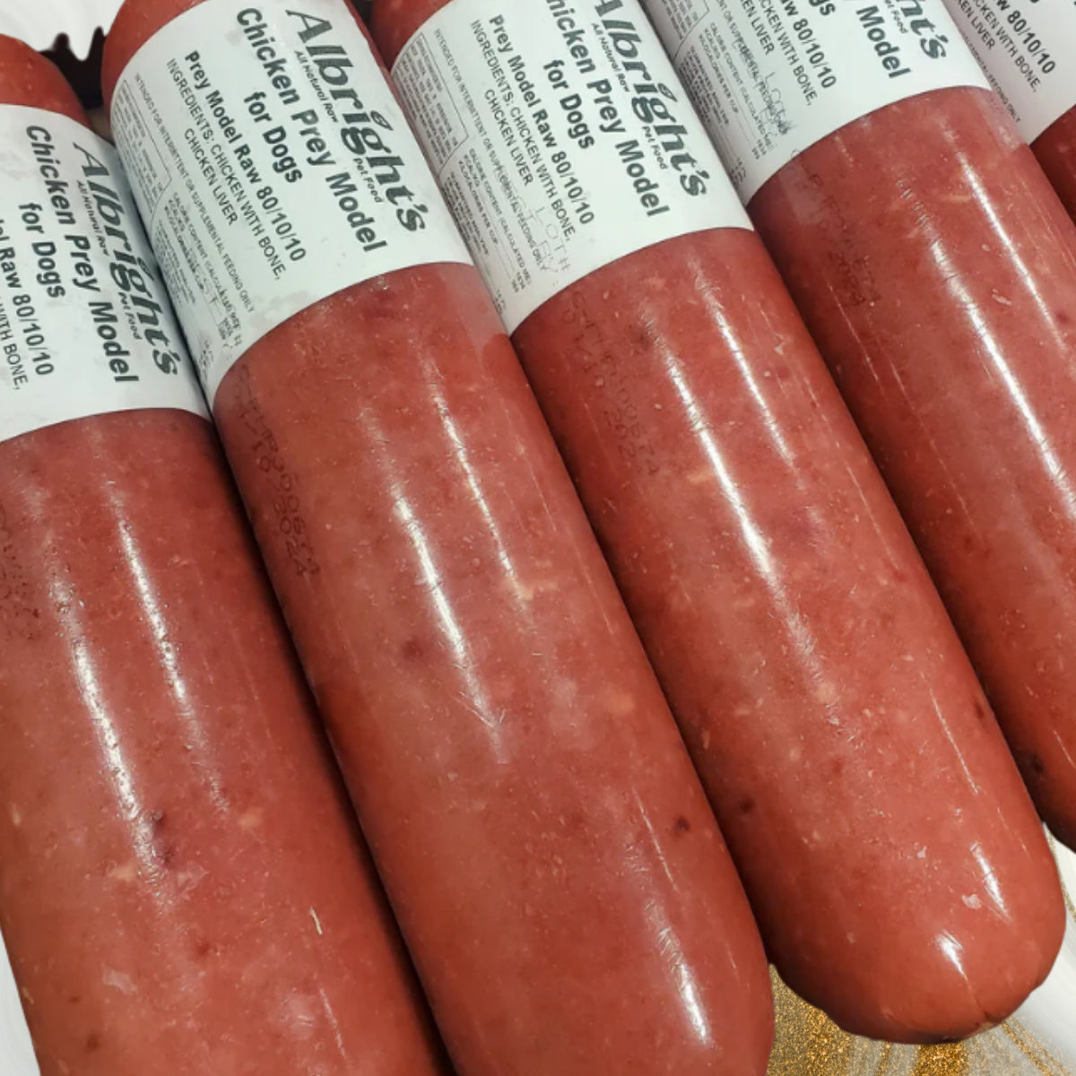 Frozen tubes of Albright’s Chicken Prey Model Raw dog food labeled 80/10/10, sold by Benny’s Raw Dog Food