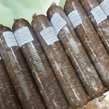 Frozen tubes of Albright’s green lamb tripe raw dog food packaged for dogs, sold by Benny’s Raw Dog Food