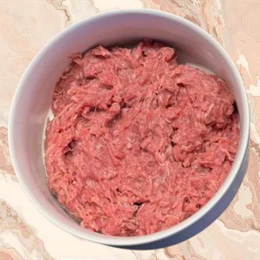 Bowl of raw ground rabbit prey model dog food, part of an 80/10/10 raw diet, sold by Benny’s Raw Dog Food