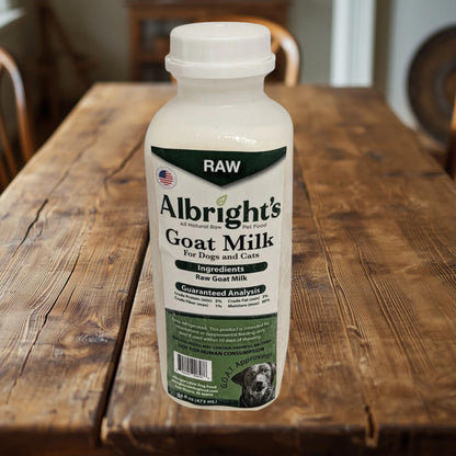 Albright’s Raw Goat Milk for Dogs 16 oz bottle on rustic farm table – Benny’s Raw Dog Food